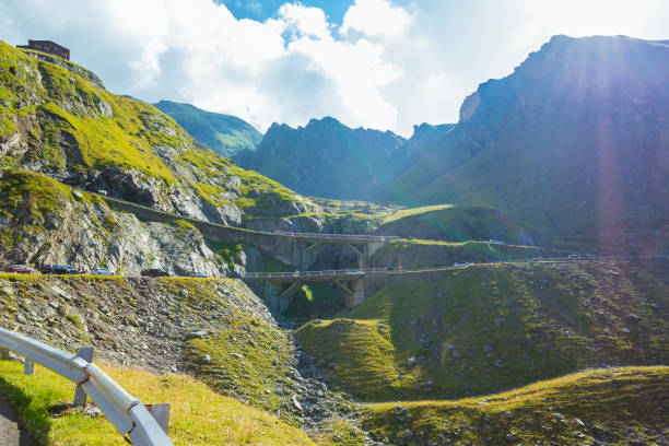 Majestic landscape of summer mountains. View of hills in rays of sunlight. Fagaras Mountains.Transylvania. Romania. Travel backdrop. Amaizing view from down on the Transfagarasan alpine mountain road