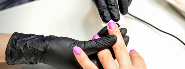 istock Manicurist applies a matte coating 1302777526