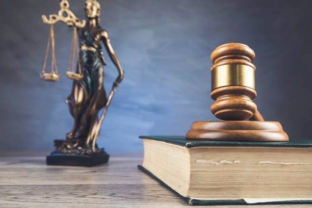 istock Justice symbols on wooden background 1302778939