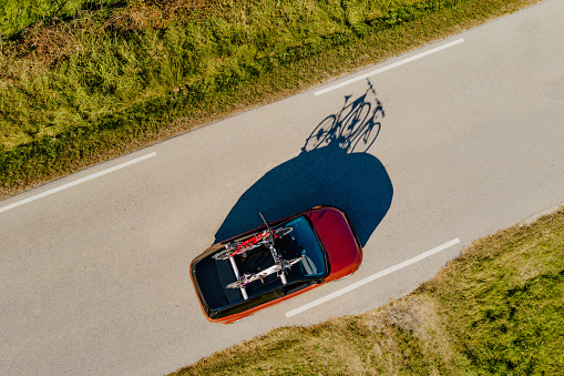High angle view of car's shadow on sunny road
