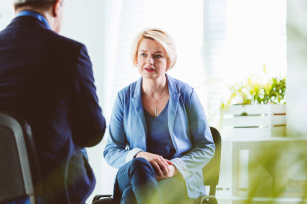 istock Businesswoman talking to coach during session 1302779135