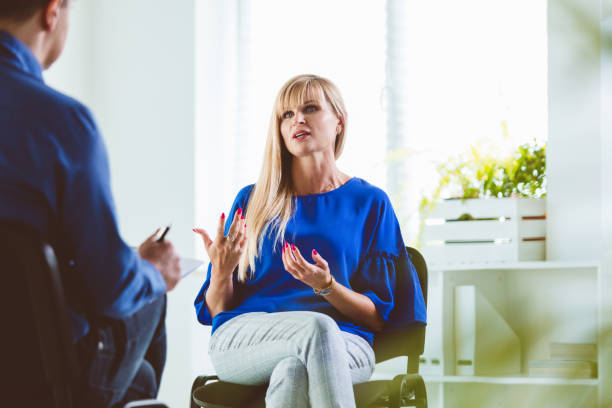 istock Businesswoman talking to coach during session 1302779287