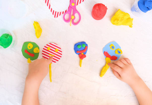 istock Child modeling fun craft . Modeling clay and paper crafts idea for kids. Activity in kindergarten and at home. 1302780060