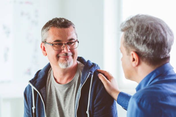 istock Mature man talking with psychotherapist in his office 1302780508