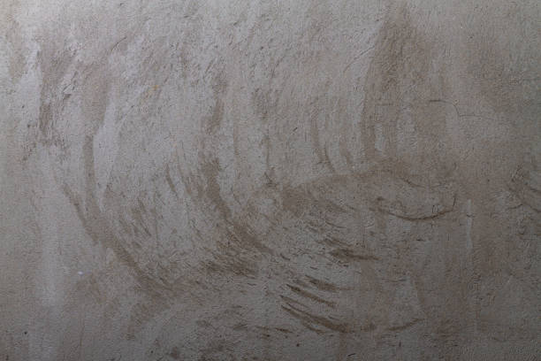 istock Concrete wall with a layer of plaster with a beautiful texture. Background 1302780608