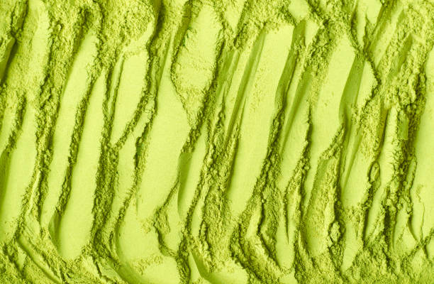 Matcha powder background. Green tea texture close-up, selective focus