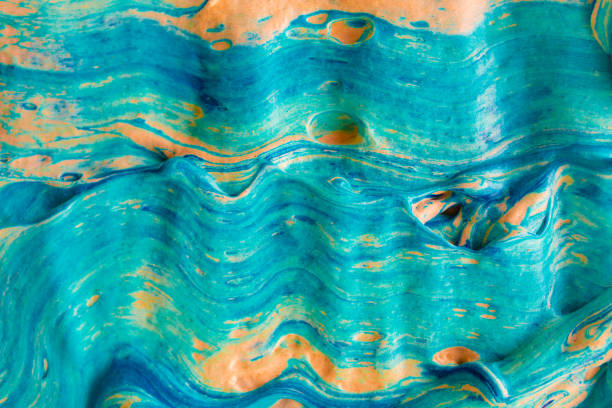 Fluid art marble abstract volume texture with blue color and orange tint. Horizontal bold rough strokes of liquid paint. Artistic Thick heavy bold smears of flowing oil acrylic paint.
