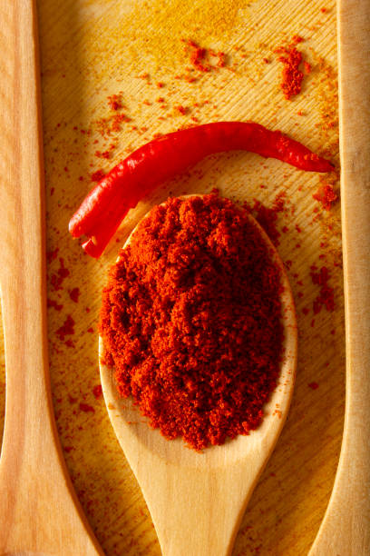 istock Red powder pepper in wooden spoon, studio shot 1302784196