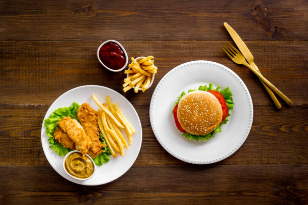 istock Burger with fried potatoes and chicken, top view 1302785458