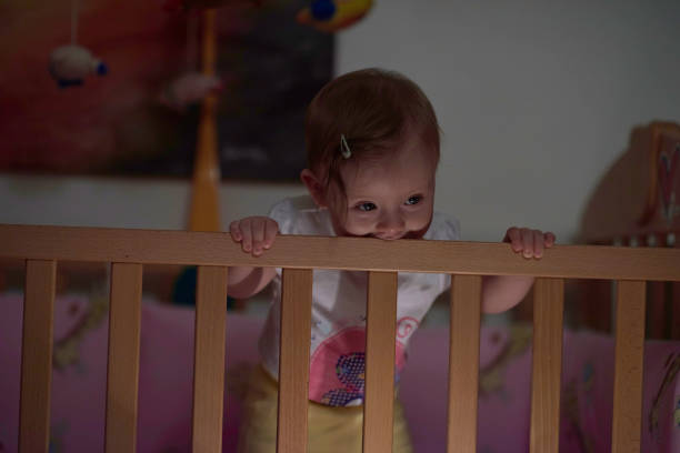 istock cute little one year old baby and making first steps in bed 1302786829