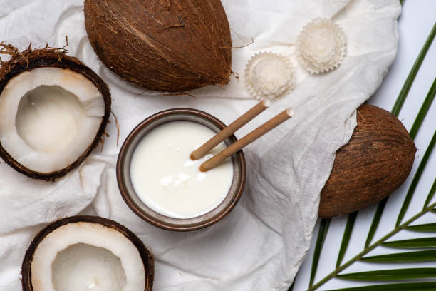istock Open dried coconut fruit and coconut milk on white background 1302787020