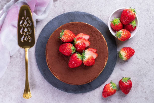 istock Tiramisu cake with strawberries on gray stone background. Top view. Copy space. 1302787041
