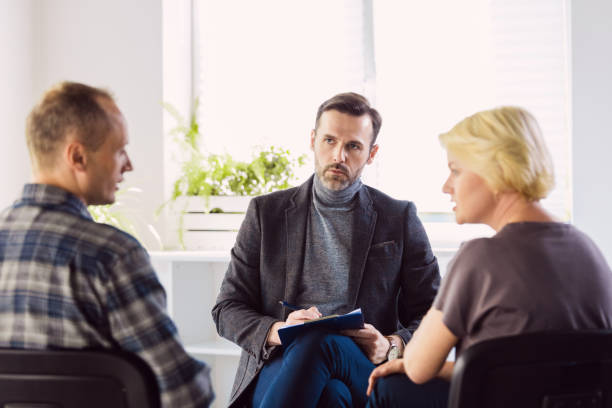 istock Psychotherapist talking with troubled couple 1302788815