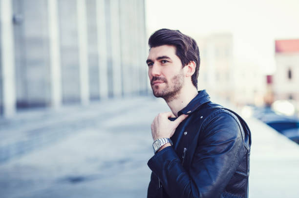 istock man in leather jacket standing in city 1302789235
