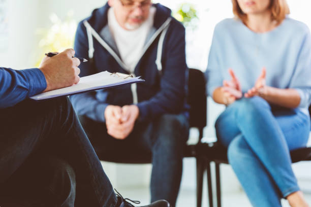 istock Troubled couple talking with psychotherapist 1302790171