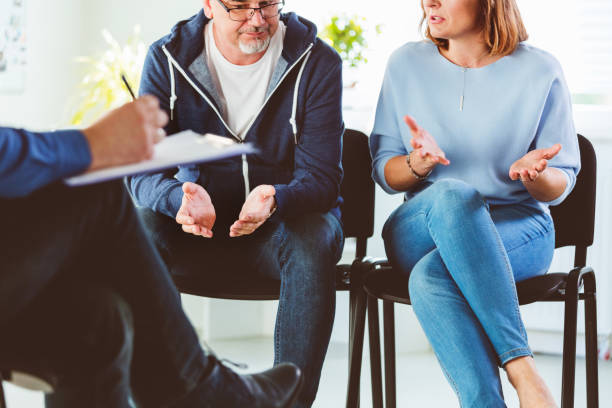 istock Troubled couple talking with psychotherapist 1302790699