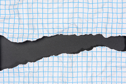 texture of crumpled white paper in a cage, blue lines, torn edges on a black background