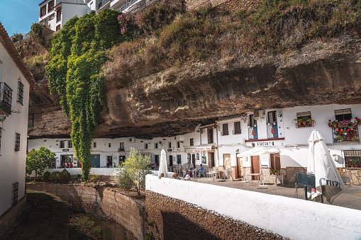 Setenil, Spain - May 8, 2019: Houses built into rocks at Cuevas del Sol Street - Setenil de las Bodegas, Cadiz Province, Andalusia, Spain
