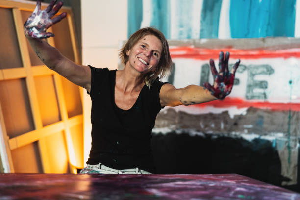 istock Woman artist painting with hands on canvas in workshop studio - Painter work and creative craft concept 1302792190