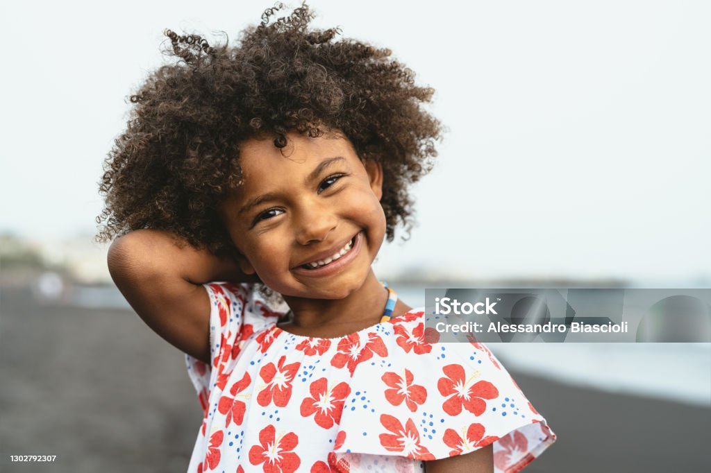 Portrait of Afro American child having fun on the beach during vacation time Child Stock Photo