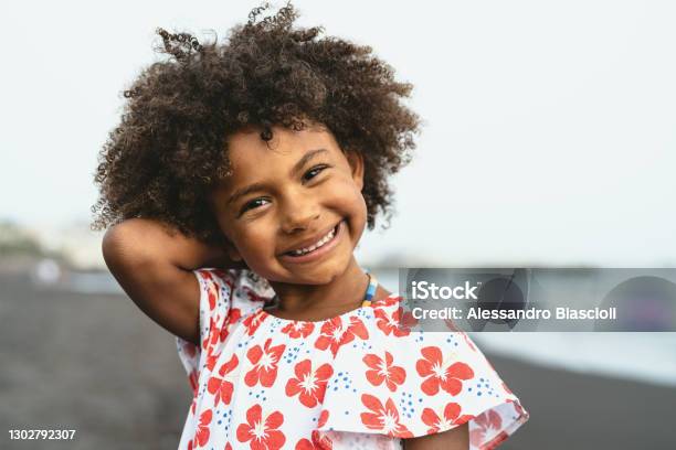 Portrait Of Afro American Child Having Fun On The Beach During Vacation Time Stock Photo - Download Image Now