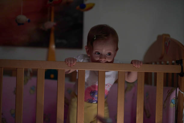 istock cute little one year old baby and making first steps in bed 1302792325