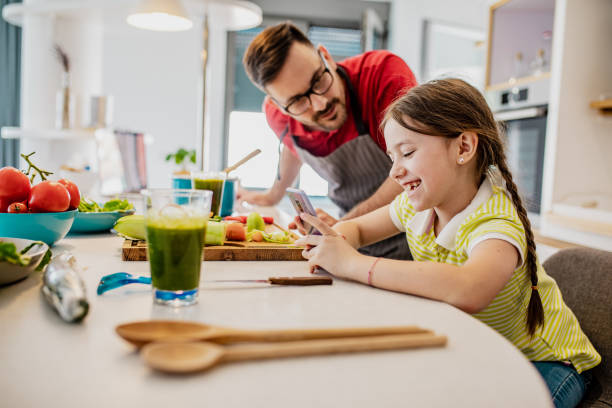 istock Father and his little daughter are in kitchen 1302793041