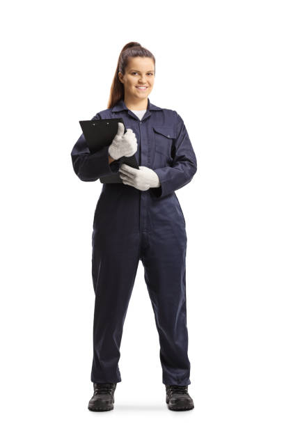Full length portrait of a female mechanic in a uniform standing and looking at camera Full length portrait of a female mechanic in a uniform standing and looking at camera isolated on white background jumpsuit stock pictures, royalty-free photos & images