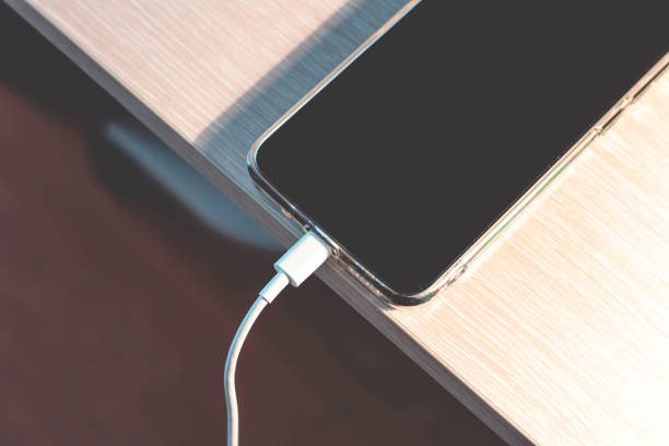 istock The process of charging a smartphone using a charger. 1302793491