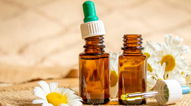 istock chamomile extract in small shoes on burlap. selective focus 1302793562