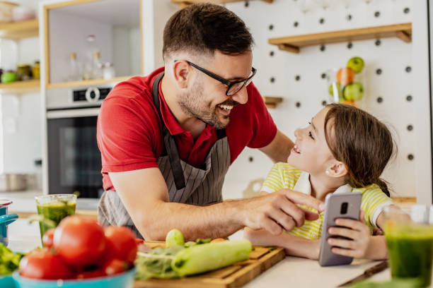 istock Father and daughter are looking for recipes online 1302793592