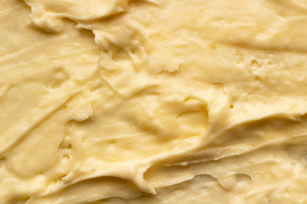 istock Yellow cosmetic cream body butter texture background. 1302793720
