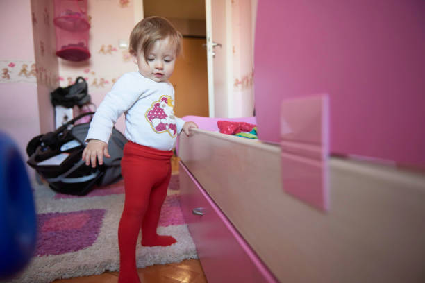 istock cute little one year old baby and making first steps 1302794303