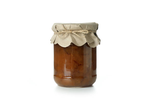 istock Glass jar of pear jam isolated on white background 1302795049