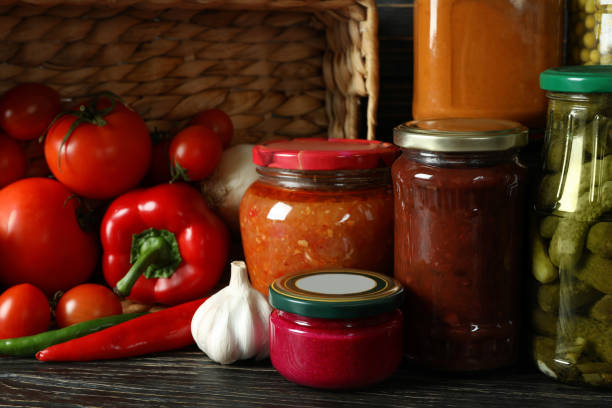 istock Jars with different canned food on wooden background 1302795285
