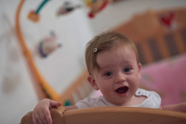 istock cute little one year old baby and making first steps in bed 1302795444
