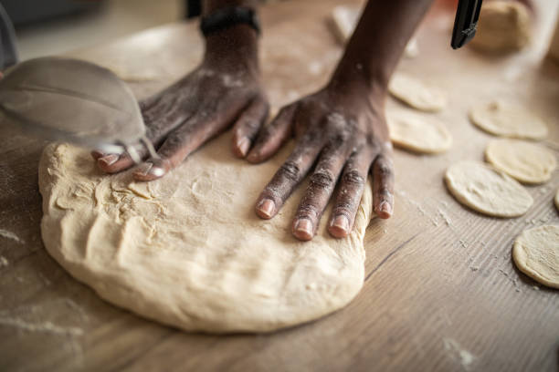 istock Woman making dough in kitchen 1302795947