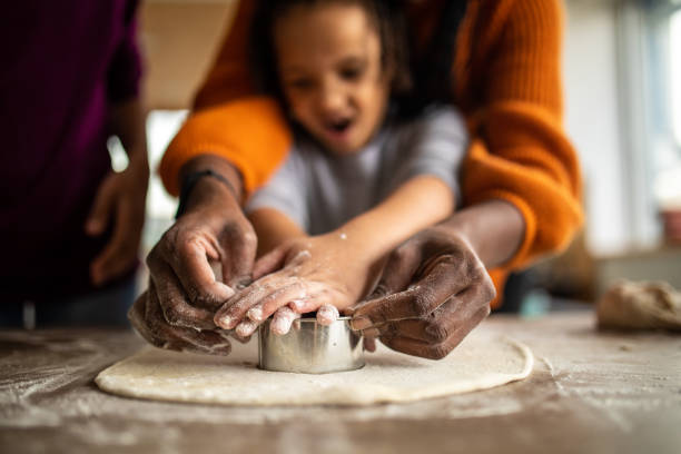istock Young family baking together in kitchen on weekend day 1302795955