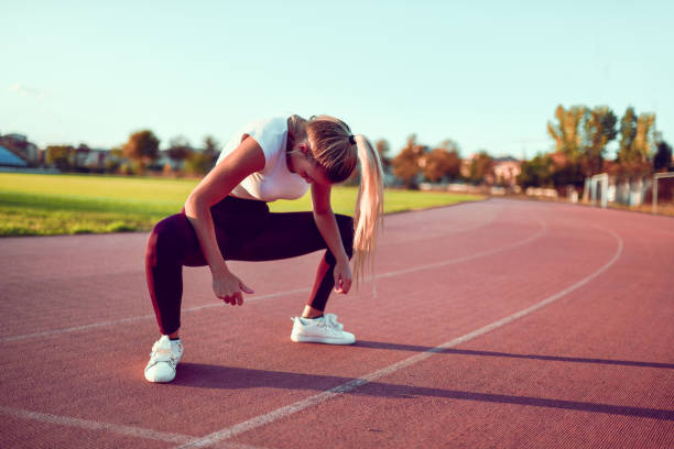 istock Cute Female Stretching Leg Muscles Before Setting Out For A Track Run 1302796676