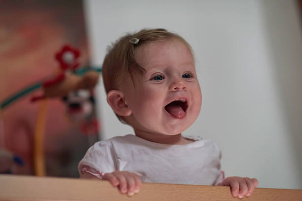 istock cute little one year old baby and making first steps in bed 1302797555