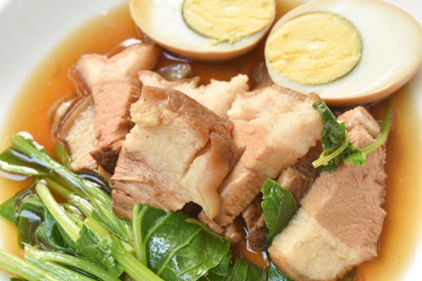 istock boiled slice pork leg and egg with Chinese kale in black herb soup 1302797642