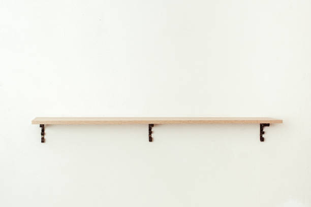 istock Empty wooden shelf on white cement wall background, product display montage 1302798479