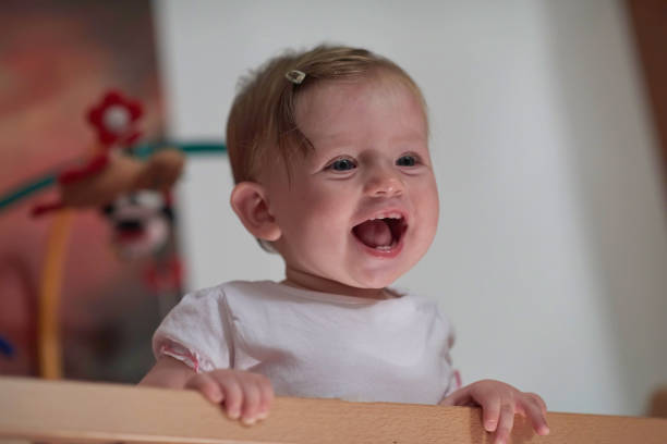 istock cute little one year old baby and making first steps in bed 1302798561