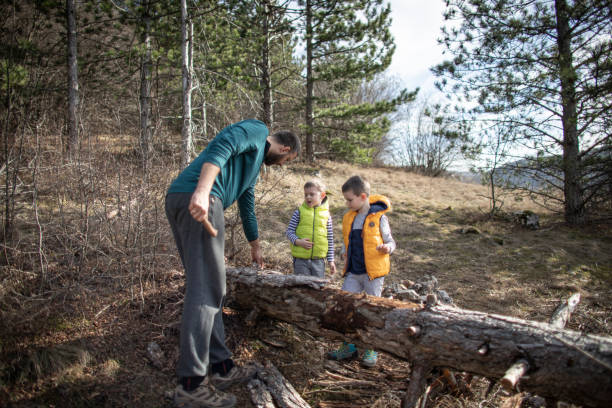 istock Boys having fun exploring the forest with their dad 1302798586