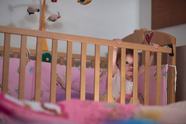 istock cute little one year old baby and making first steps in bed 1302798932