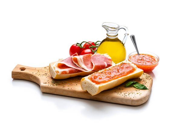 slice of toast bread with ham, basil and tomatoe