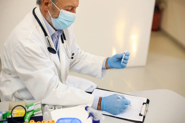 istock Senior doctor writing test results 1302802528
