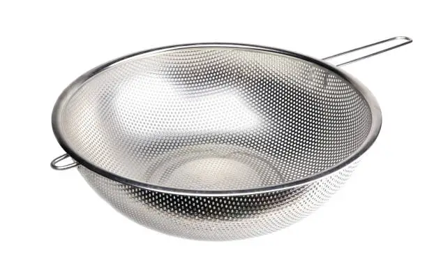 A metal colander isolated on a white background. A strainer isolated. A sieve.