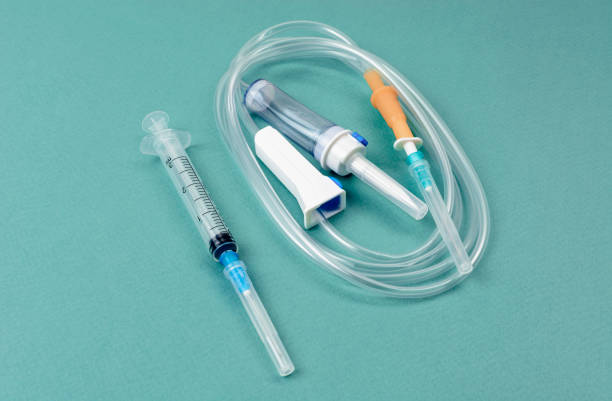 istock Syringe with dropper on green background. Blood transfusion concept. 1302805207