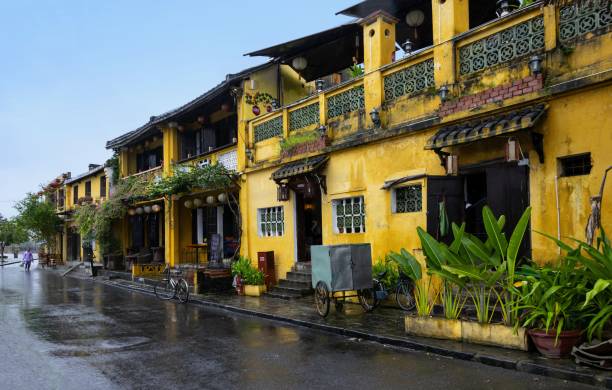 Rainy Vietnamese city of Hoi An Hoi An, Vietnam, December 1, 2014: View of a riverside street in this central Vietnamese city. It is raining very often here. The center of Hoi An is listed as UNESCO World Heritage Site. central vietnam stock pictures, royalty-free photos & images